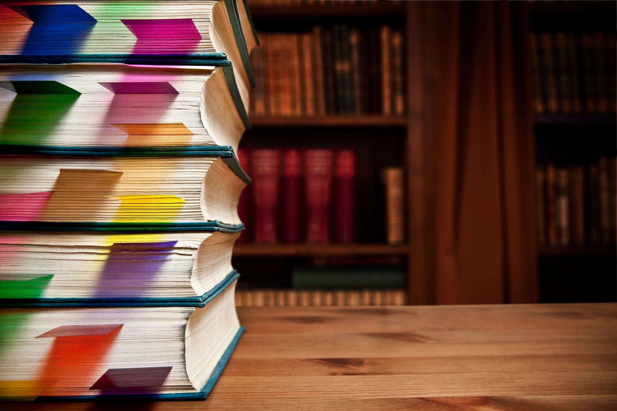 Stack of bookmarked books representing learning and reflection